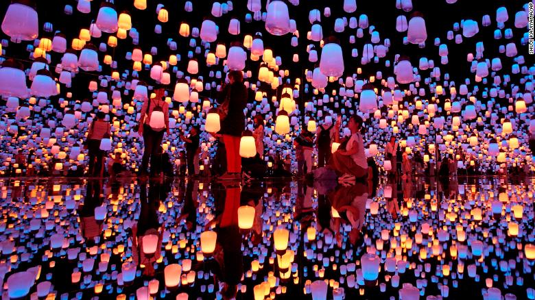 Visitors walk through the installation of &quot;Forest of Resonating Lamps&quot; at the Mori Building Digital Art Museum in Tokyo, Thursday, June 21, 2018. Mori Building, a Japanese real estate company and teamLab, digital art collective company, have joined together to create the digital art museum in Tokyo. &quot;MORI Building DIGITAL ART MUSEUM: teamLab Borderless&#39;&quot; exhibition displayed 50 interactive artworks in a 10,000 square-meter space. (AP Photo/Shuji Kajiyama)
